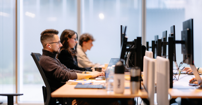 Employees of Orbio World working in an open space office