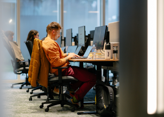 Employees of Orbio World working in an open space office