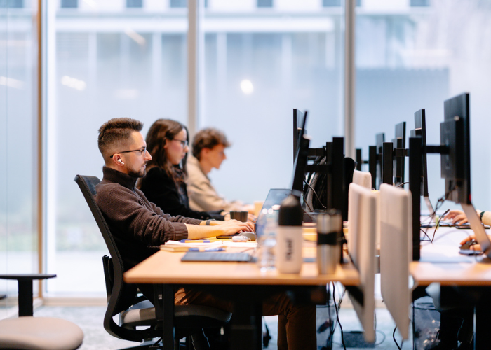 Employees of Orbio World working in an open space office